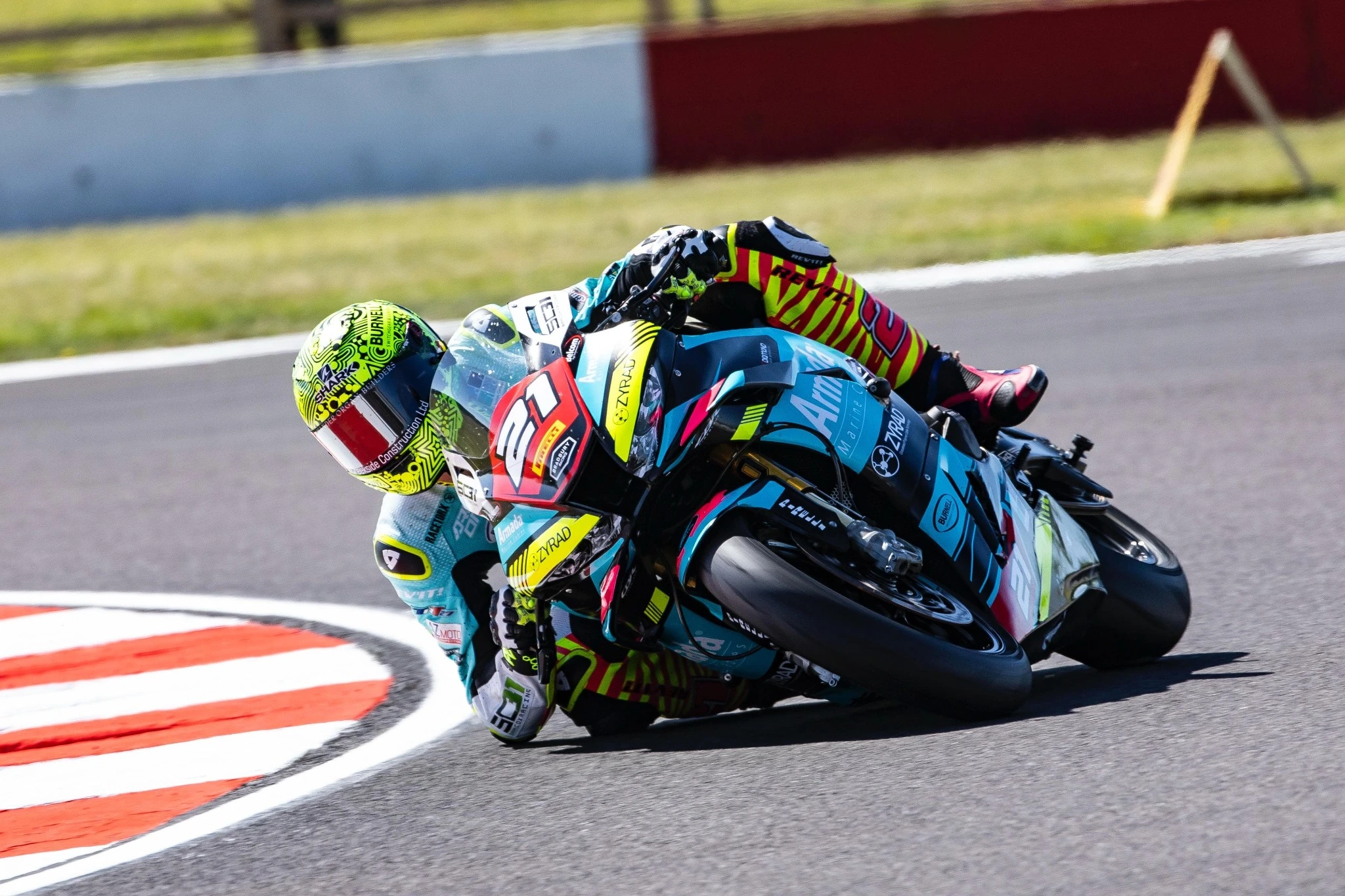 Motorcycle racer cornering at speed on circuit